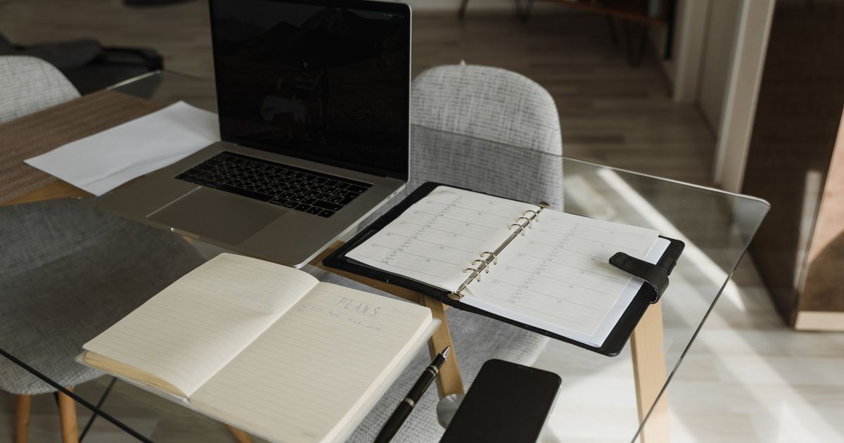 Laptop, notebook and planner in an organized workspace